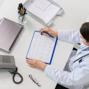 medicine-healthcare-cardiology-people-concept-doctor-with-cardiogram-phone-laptop-computer-sitting-table-clinic_380164-181653