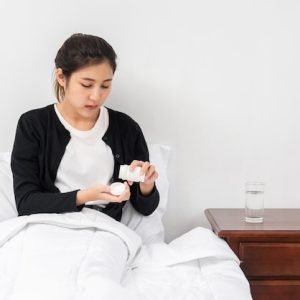 woman-who-is-unwell-couch-is-about-take-antibiotics_1150-26084